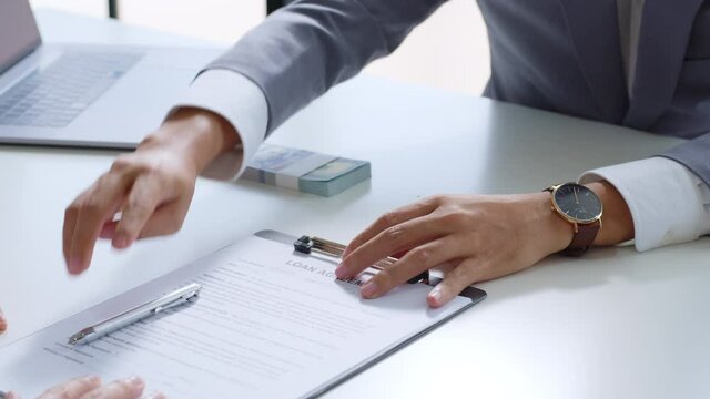 Businessman sign on money loan agreement contract to banker, loan and credit financial lease concept