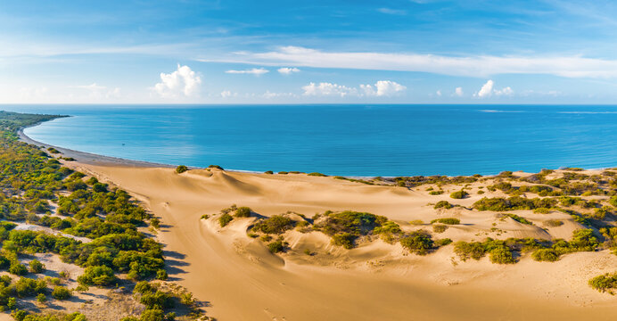 Panoramic aerial view of the dunes of Bani on a sunny day with the Caribbean Sea behind on a sunny day, Peravia, Dominican Republic