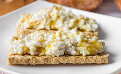 breakfast of bread with cottage cheese and honey