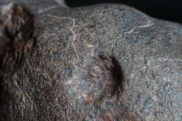 Macro photo of the fusion crust from a Chondrite Meteorite, piece of rock formed in outer space in...