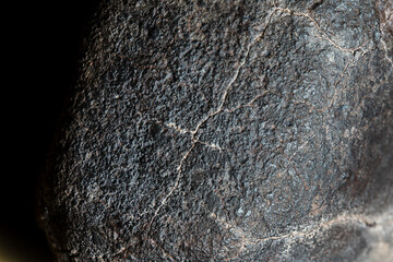 Macro photo of the fusion crust from a Chondrite Meteorite, piece of rock formed in outer space in...
