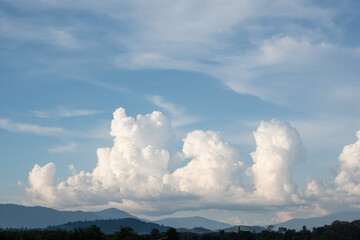 The white clouds have a strange shape and moutain.