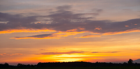 Colorful sunset and sunrise with clouds.Blue and orange color of nature.Many white clouds in the blue sky.The weather is clear today.sunset in the clouds.The sky is twilight