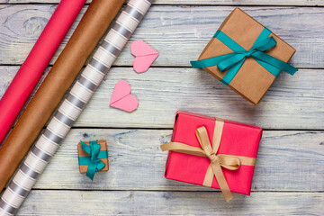Gift boxes, wrapping paper and hearts on a light table. Flat Lay. Gift wrapping process