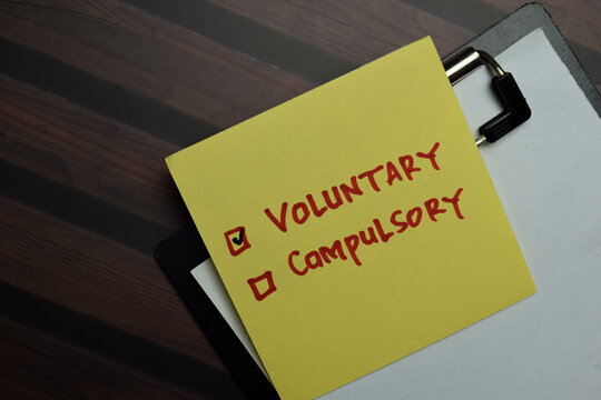 Voluntary and Compulsory write on sticky notes and supported by additional services write on a sticky notes isolated on Wooden Table.
