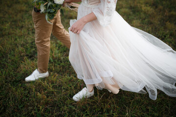 Fototapeta premium Legs of the bride and groom.