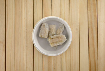 Banana in Coconut Milk.Dessert of Thailand Placed on a wooden background.