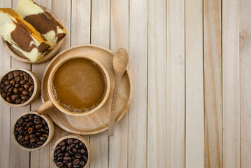 Espresso coffee in a wooden cup (top view) with bread, coffee beans Placed on a wooden background.copy space.