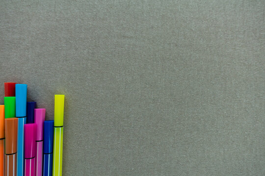 Color pens, in various colors on beige copy space template background. 