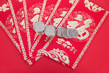 Red envelopes and dollar coins on a red background