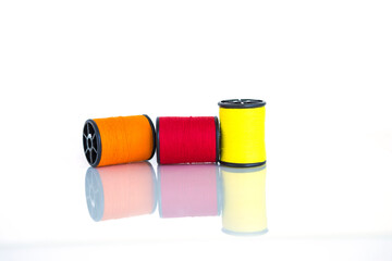 Colorful theread spool for sewing isolate on white background, textile equipment manufacture concept