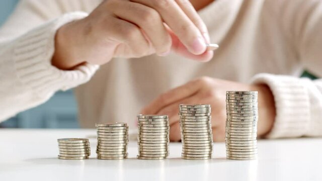Closeup man hand stacking coin for save money concept