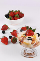Home Made Yogurt  topped with Berries on White Background
