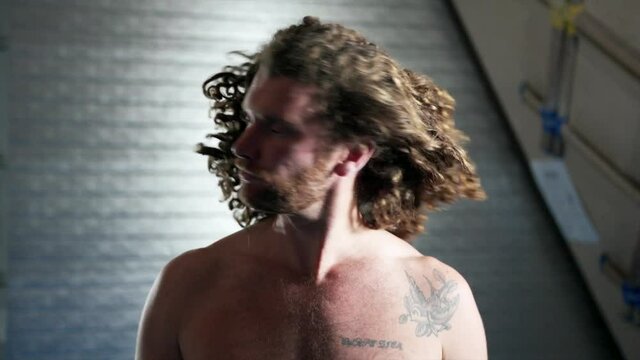 Tall slim shirtless caucasian man with long hair looks up at camera and takes down log curly hair from bobble. Funny cut away from rock climbing session. 

1080P 25FPS 10bit SLOG2-REC709