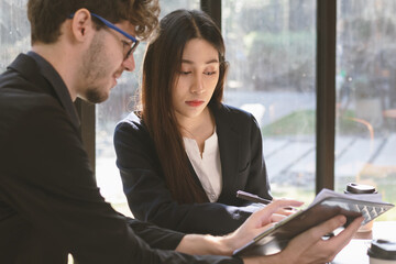 Business professional people group, team of young asian, caucasian working and communicating, analyzing data, discussing, using laptop computer explain about new project with colleagues in workplace.