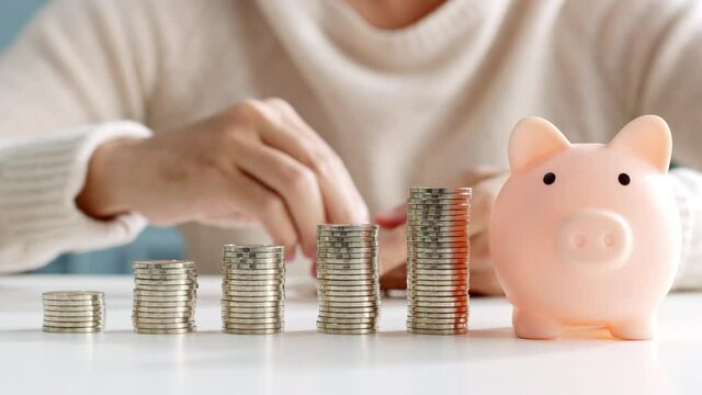 Closeup man hand stacking coin for save money concept