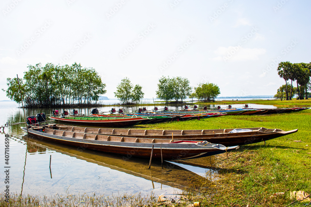 Wall mural long-tailed boats moored by the water