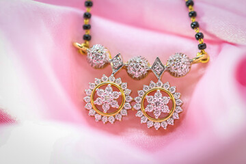 Close up shot of original diamond pendent on pink satin fabric