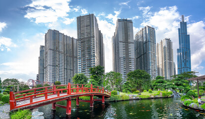 Path bridge over central park in busy urban areas showing prosperous economic development in Ho Chi Minh City, Vietnam