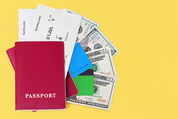 Passport, boarding pass, flight ticket, cash money currency, us dollars, credit card yellow background closeup top view, passenger control, travel holidays, vacation, international tourism, copy space