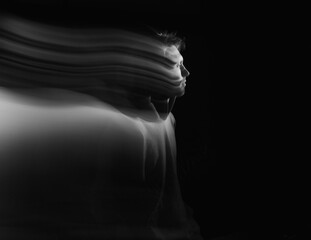 Facial face of a man in the dark. Art photography. Black-white art picture with a man. Portrait of man with blurred motion