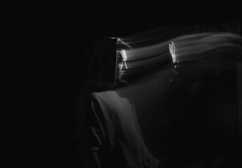 Facial face of a man in the dark. Art photography. Black-white art picture with a man. Portrait of man with blurred motion