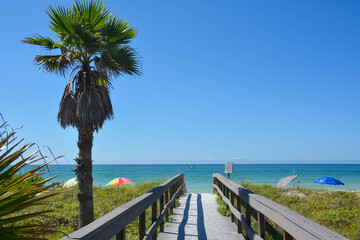 View of clear blue skies and calm ocean waters on a lovely warm sunny summer beach day from the boardwalk in St Petersburg / Clearwater Beach in Florida