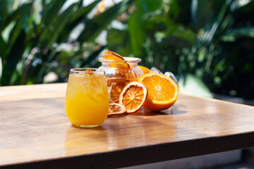 Fresh Summer Orange Cocktail on table outside in front of trees with fresh fruit. Great on it's...