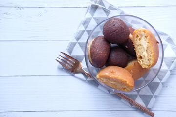 close up of indian sweet in a bowl on white table with copy space 