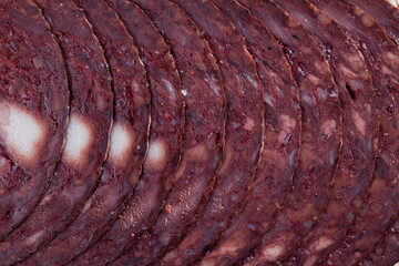 European cuisine blood pudding on white plate on wooden table