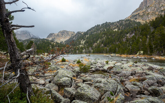 Autumn landscape of Ratera de Colomers lake, glacial origin lake surrounded by Spanish Pyrenees in Aiguestortes National Park, Pallars Sobira, Catalonia, Spain