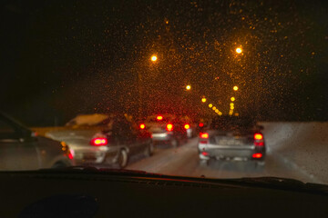 Cars in traffic in winter in the evening dark