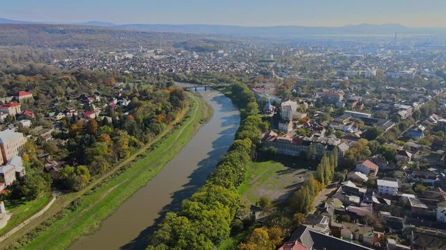 Small town panoramic view from above in the autumn over the Uzh River during the sunset Uzhhorod Ukraine Europe