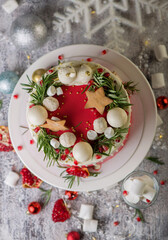 Fototapeta na wymiar Christmas or New Year decorated cake with cream cheese frosting and cranberries, selective focus