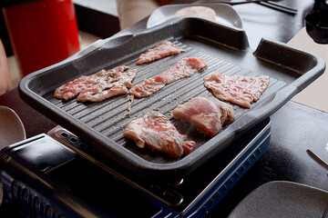People grilling korean barbeque