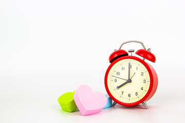 Red analog clock with plastic heart shape for time of love symbol,isolated
