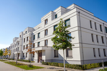Fototapeta na wymiar Street with modern white townhouses in Berlin, Germany