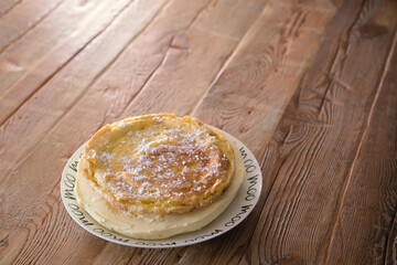 homemade cake with cream on the table from old boards