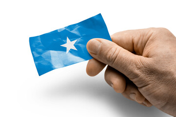 Hand holding a card with a national flag the Somalia