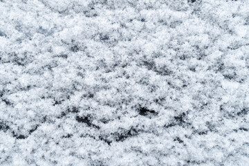 Background of fresh white snow. Winter snowflakes texture. Snow white texture winter background. Icy surface pattern. Shiny snow with bokeh