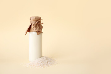 Fototapeta premium Bottle of rice milk on color background