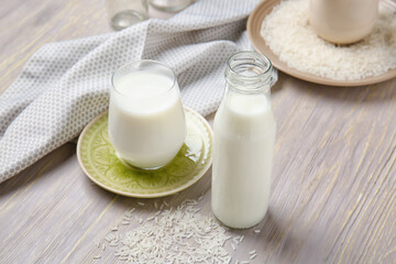 Fototapeta na wymiar Bottle and glass of rice milk on table