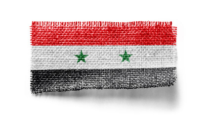 Syria flag on a piece of cloth on a white background