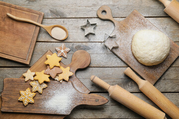 Tasty cookies, dough and rolling pins on wooden background