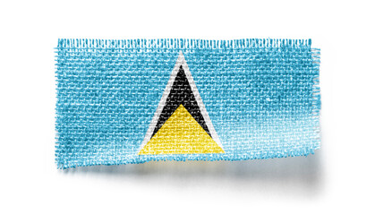 Saint Lucia flag on a piece of cloth on a white background