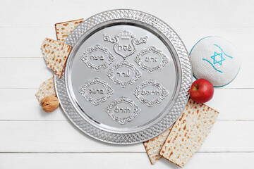 Passover Seder plate with matzo and Jewish cap on wooden background