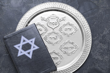 Passover Seder plate with Torah on dark background