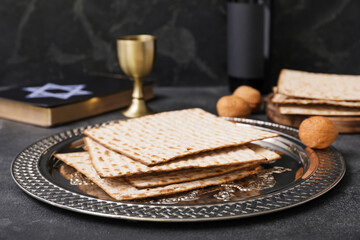 Passover Seder plate with matzo on dark background
