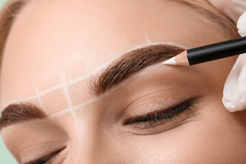 Young woman undergoing eyebrow correction procedure, closeup