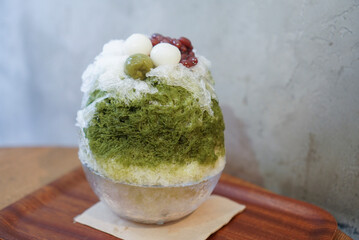 Uji matcha kakigori, Shaved ice in japanese style. Green tea shaved ice topped with dango and red...